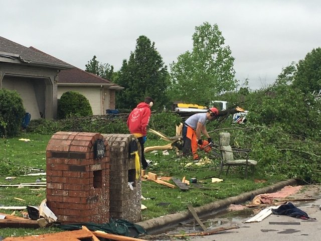 A crew with Convoy of Hope cleans up debris from Tuesday’s storm in Ozark’s Waterford subdivision.